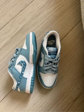 Nike Low-Top Sneakers in White and Light Blue with Patterned Swoosh